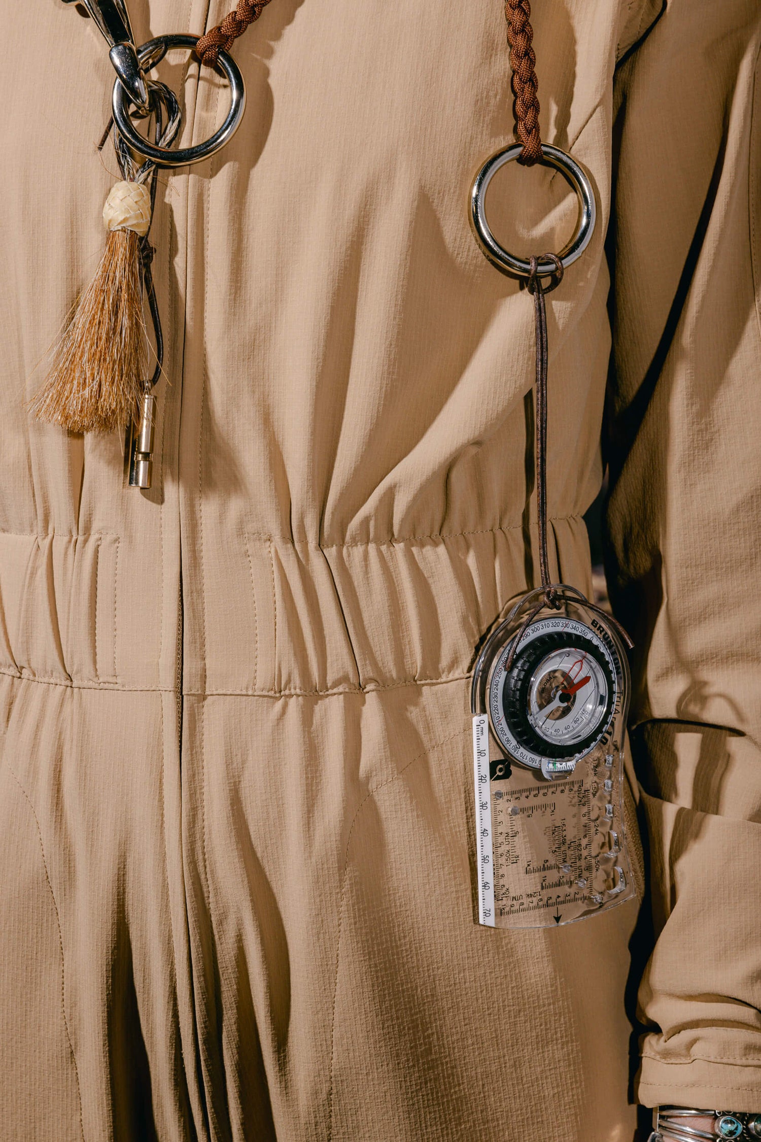 Woman wearing The Huntress Outdoor Tackle Suit and Bridle Necklace with Compass