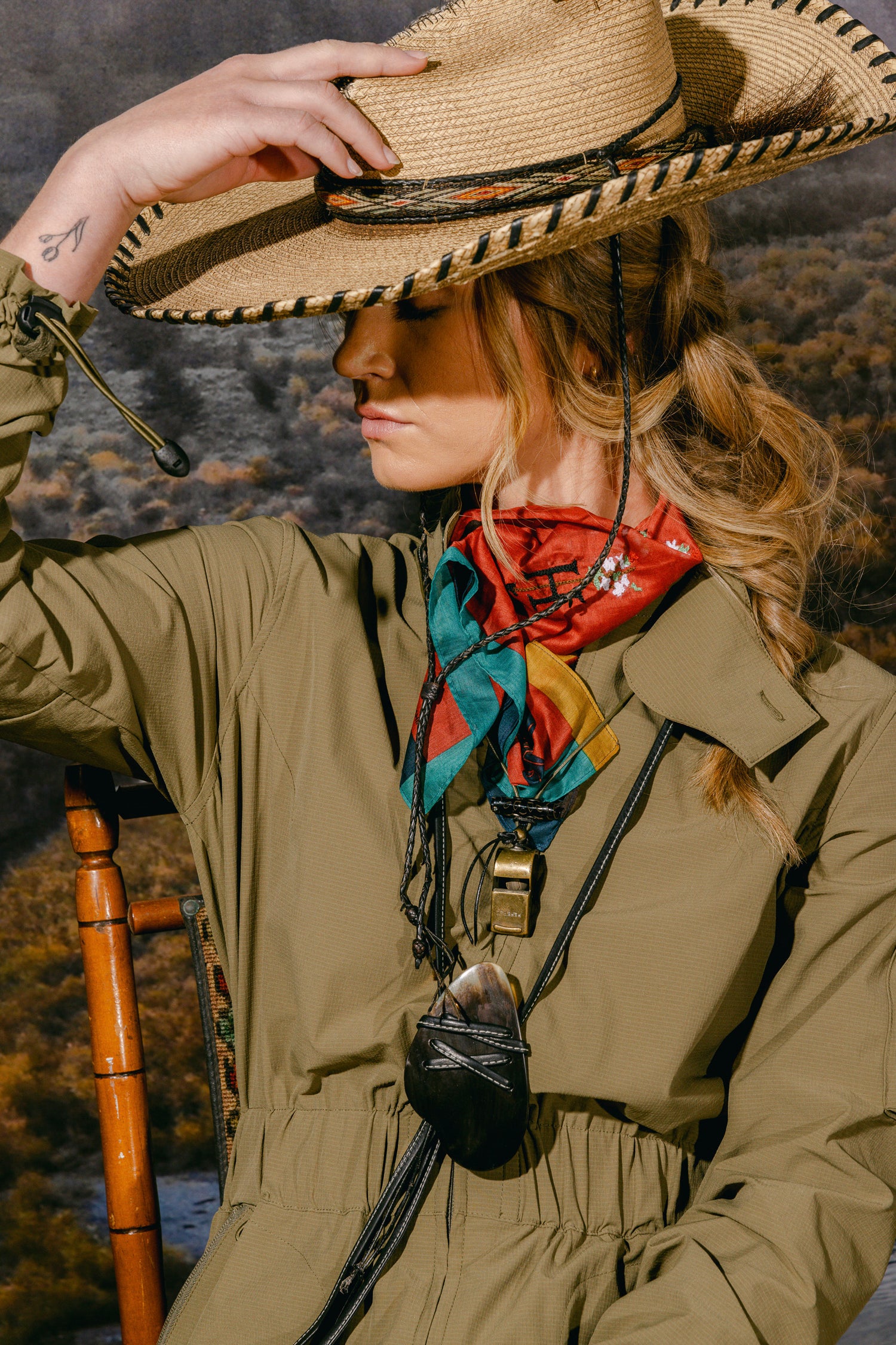 Woman wearing The Huntress Outdoor Tackle Suit, bandana and accessories