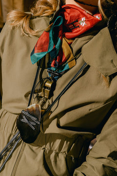 Woman wearing the Sage Tackle Suite, Leather Fly Whistle Necklace and Bandana