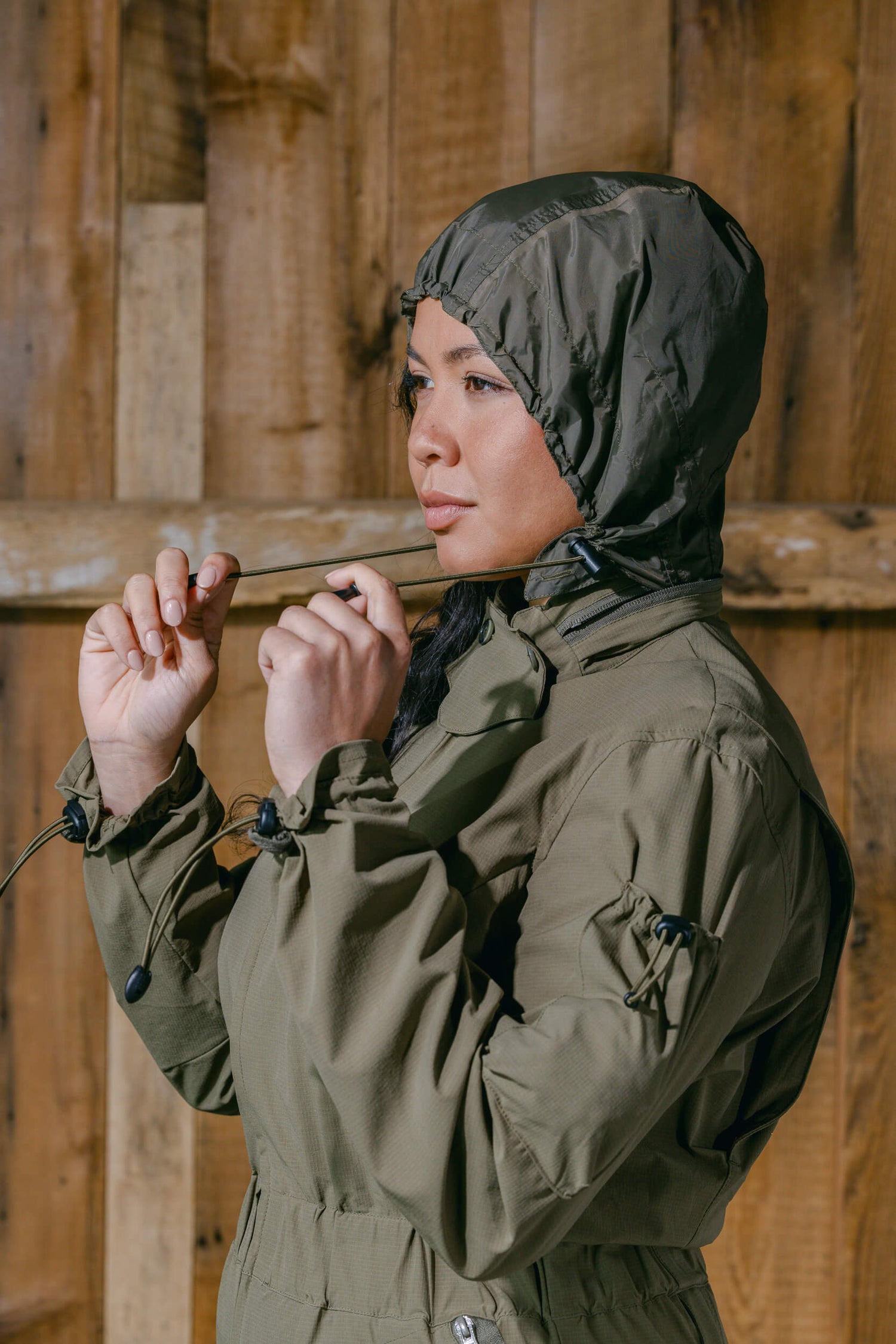 The Huntress Outdoor Tackle Suit water resistant hood in Sage